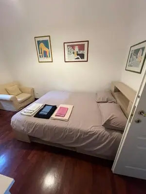 a bedroom with a bed and a chair at Casa Ale in Rome