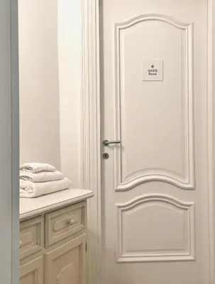 a white door with a sign on it in a bathroom at Biffi 2 - Garbatella Rooms in Rome