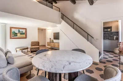 a living room with a table and chairs at Cisterna 8 in Rome