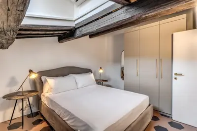 a bedroom with a bed in a room with ceilings at Cisterna 8 in Rome