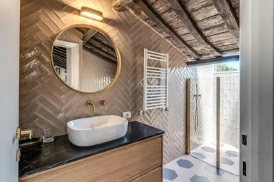 a bathroom with a sink and a mirror at Cisterna 8 in Rome
