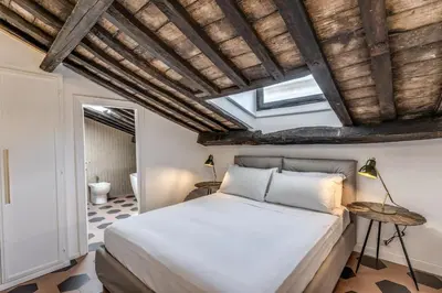 a bedroom with a bed and a vaulted ceiling at Cisterna 9 in Rome