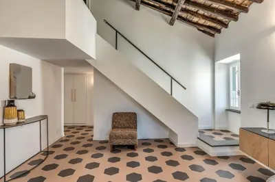 a stair room with a chair and a stair case at Cisterna 9 in Rome