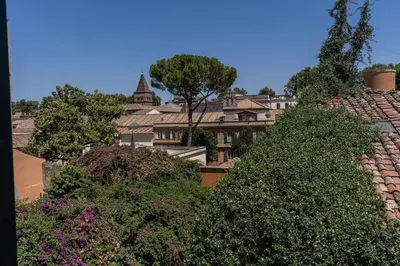 a view of a building with trees and bushes at Cisterna 9 in Rome