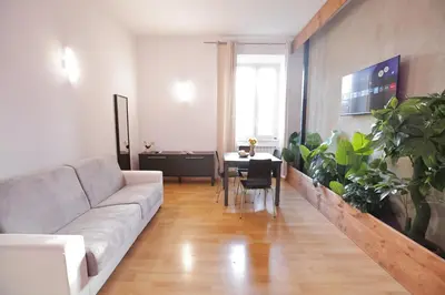 a living room with a couch and a table with plants at The Holy Apartments in Rome