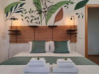 a bedroom with a large bed with towels on it at The Holy Apartments in Rome