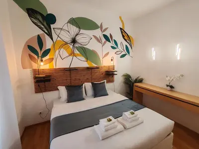 a bedroom with a bed with towels on it at The Holy Apartments in Rome