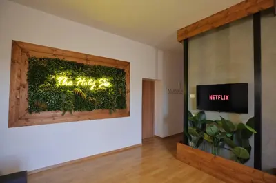 a room with a green wall with a sign on it at The Holy Apartments in Rome