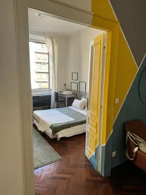 a small bedroom with a bed and a window at A Colorful Spot for La Dolce Vita in Rome