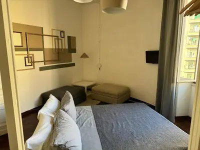 a small bedroom with a bed and a couch at A Colorful Spot for La Dolce Vita in Rome
