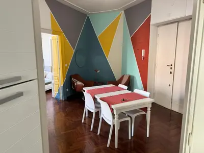 a dining room with a table and a colorful wall at A Colorful Spot for La Dolce Vita in Rome