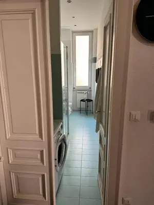 a bathroom with a washing machine and a door at A Colorful Spot for La Dolce Vita in Rome