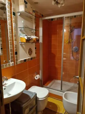 a bathroom with a toilet and a sink and a shower at Casa BiBi in Rome