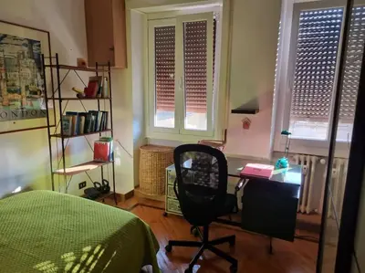 a bedroom with a desk and a chair and a bed at Casa BiBi in Rome
