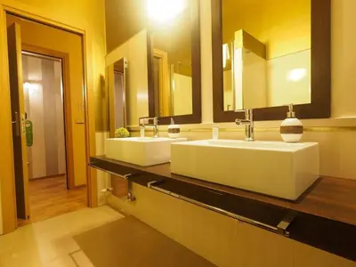 a bathroom with two sinks and two mirrors at House Borgia in Rome