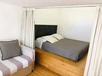 a small bedroom with a bed and a window at Stylish Duplex Apartment with Private Terrace in Rome