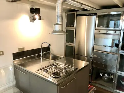 a kitchen with a sink and a stove top oven at Stylish Duplex Apartment with Private Terrace in Rome