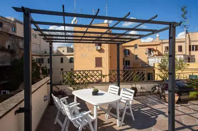 a patio with a white table and chairs on a balcony at Interno Otto con Bellissima Terrazza e Gazebo in Rome