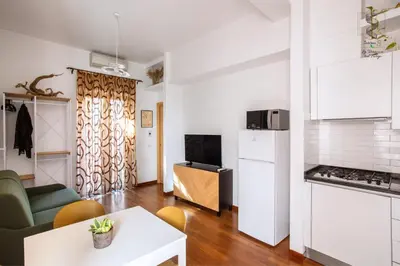 a kitchen and living room with a couch and a table at Interno Otto con Bellissima Terrazza e Gazebo in Rome