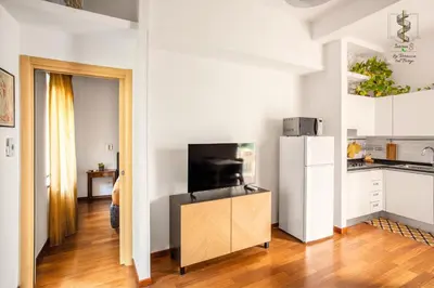 a kitchen with white cabinets and a refrigerator at Interno Otto con Bellissima Terrazza e Gazebo in Rome