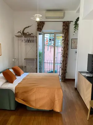 a bedroom with a large bed with orange pillows at Interno Otto con Bellissima Terrazza e Gazebo in Rome