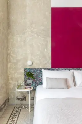 a bedroom with a white bed and a pink wall at Ehi Bnb in Rome