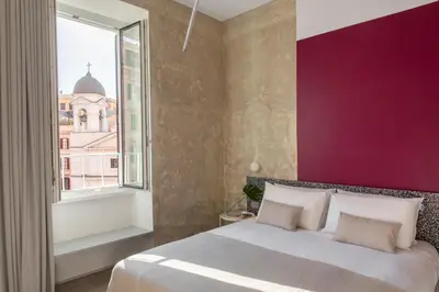 a bedroom with a large bed and a window at Ehi Bnb in Rome