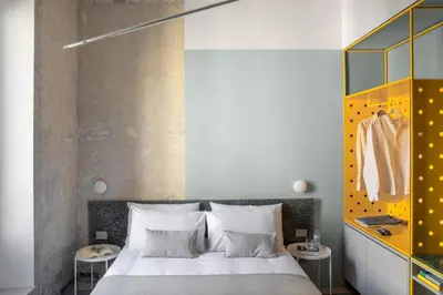 a bedroom with a bed and two tables and a closet at Ehi Bnb in Rome
