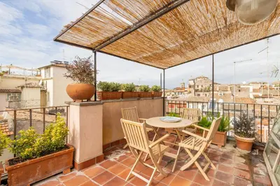 a patio with a table and chairs on a balcony at Pantheon Apartment with Terrace in Rome