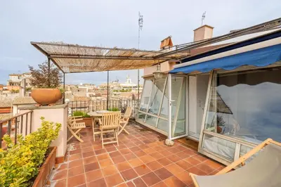 a patio with a table and chairs on a balcony at Pantheon Apartment with Terrace in Rome