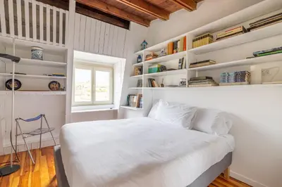 a bedroom with a white bed and shelves at Pantheon Apartment with Terrace in Rome