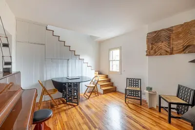 a living room with a table and a staircase at Pantheon Apartment with Terrace in Rome