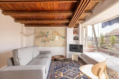 a living room with a couch and a tv at Pantheon Apartment with Terrace in Rome