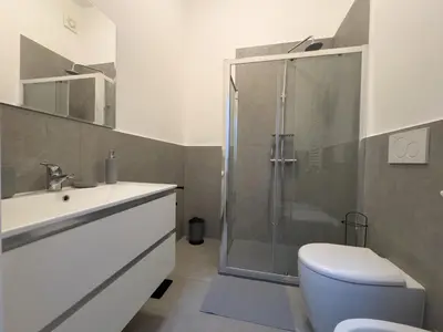 a bathroom with a shower and a toilet and a sink at I ricordi di San Pietro in Rome