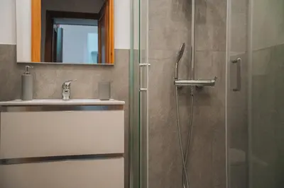 a bathroom with a shower and a sink and a mirror at I ricordi di San Pietro in Rome