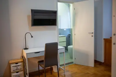 a room with a desk and a television on a wall at I ricordi di San Pietro in Rome
