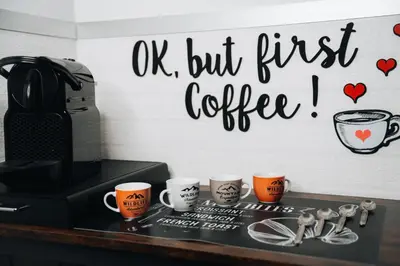 a sign that says ok but first coffee on a wall at I ricordi di San Pietro in Rome