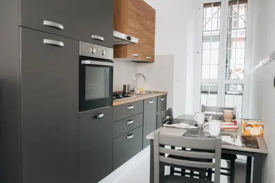 a kitchen with a table and a stove top oven at I ricordi di San Pietro in Rome