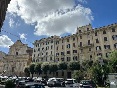 a large building with cars parked in a parking lot at I ricordi di San Pietro in Rome