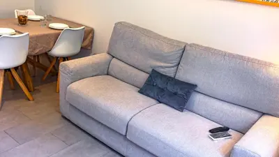 a living room with a couch and a table at Re di Roma Metro Hub - Rome Collection in Rome