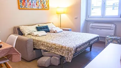 a small bedroom with a bed and a couch at Re di Roma Metro Hub - Rome Collection in Rome