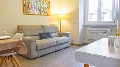 a living room with a couch and a table at Re di Roma Metro Hub - Rome Collection in Rome