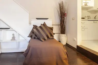 a bed in a room with a stair case at Navona Dream Flat in Rome