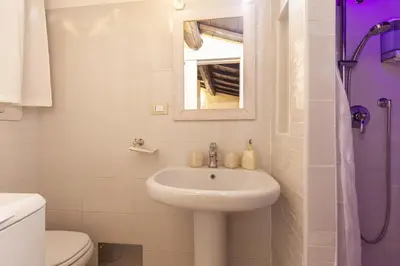 a bathroom with a sink and a toilet and a mirror at Navona Dream Flat in Rome