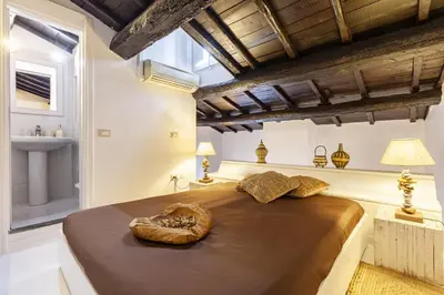 a bedroom with a large bed and a sink at Navona Dream Flat in Rome