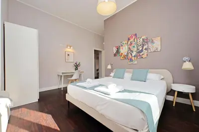 a bedroom with a large white bed in a room at 4BNB - Armot House Vatican Apartment in Rome