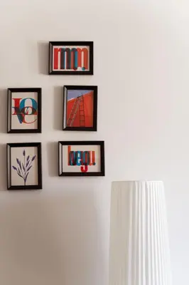 a wall with four framed pictures on a wall at Sergio i Retreat in Rome