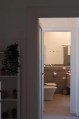 a bathroom with a toilet and a mirror at Sergio i Retreat in Rome