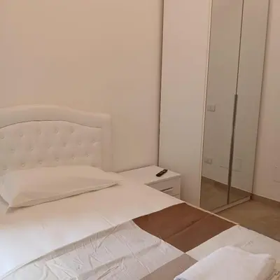 a bedroom with a white bed and a mirror at Grand Nomentana Roma in Rome