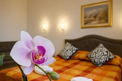 a purple flower sitting on top of a bed at NEXUS Palace in Rome